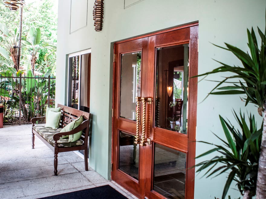The entrance of the Mutiny Hotel in Coconut Grove, Miami: wooden doors under a covered walkway.